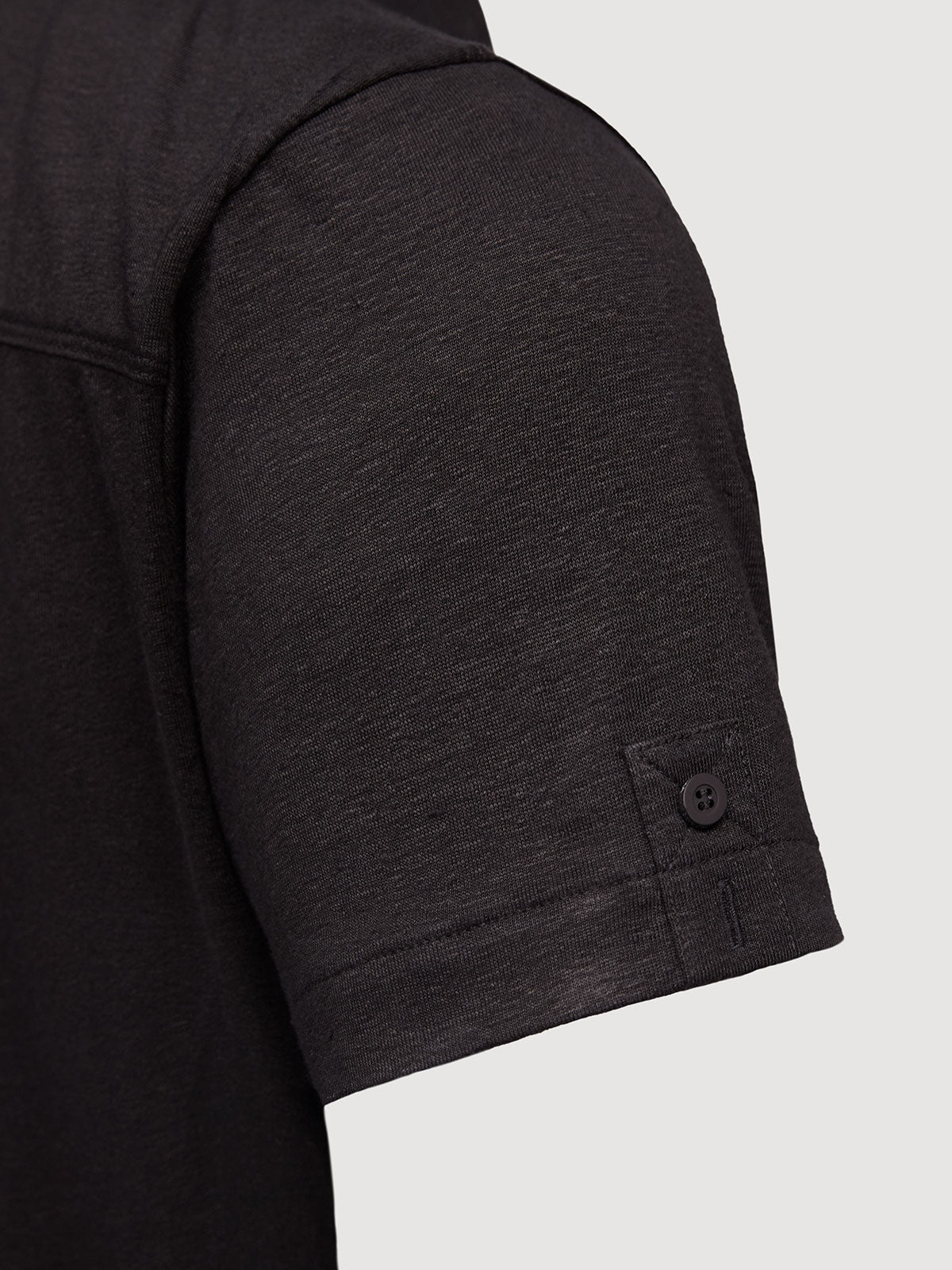 Madeira French Linen Short Sleeve Polo in *Berlin Black* (black) — sleeve uncuffed detail | Y.Chroma