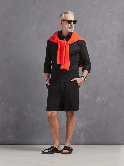 Madeira French Linen Long Sleeve Polo in *Berlin Black* (black) styled with Berlin Black Retinol Short and Aperol Orange Dwayne V-Neck Cashmere Sweater on shoulders — full length lookbook | Y.Chroma