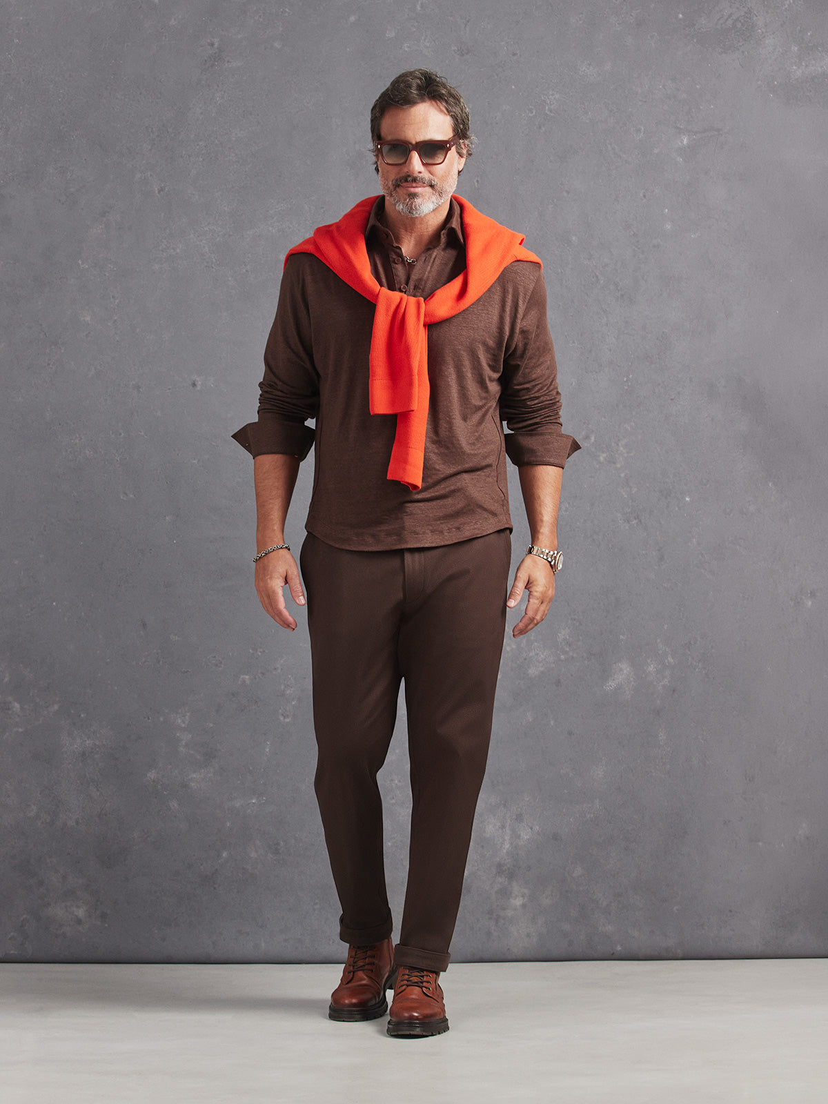 Madeira French Linen Long Sleeve Polo in *Java Brown* (warm brown) styled with Java Brown Becker Pant and Aperol Orange Dwayne V-Neck Cashmere Sweater on shoulders — full length lookbook | Y.Chroma