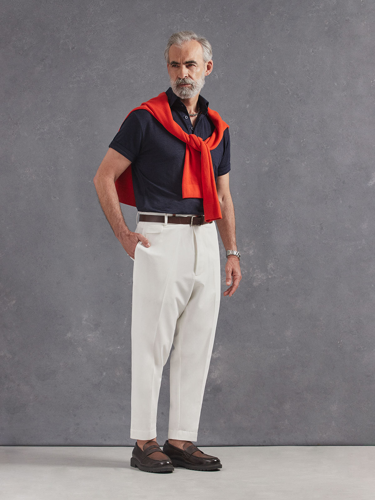 Madeira French Linen Short Sleeve Polo in *Midnight Blue* (navy blue) styled with White Lotus Retinol Pant and Aperol Orange Dwayne V-Neck Cashmere Sweater on shoulders — full length lookbook | Y.Chroma