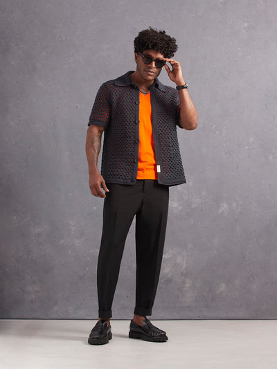 Retinol Pant 2026 Edition in *Berlin Black* (black) styled with Aperol Orange v-neck shirt and Obsidian Gray Grand Prix Hand Crocheted Shirt — full length lookbook | Y.Chroma